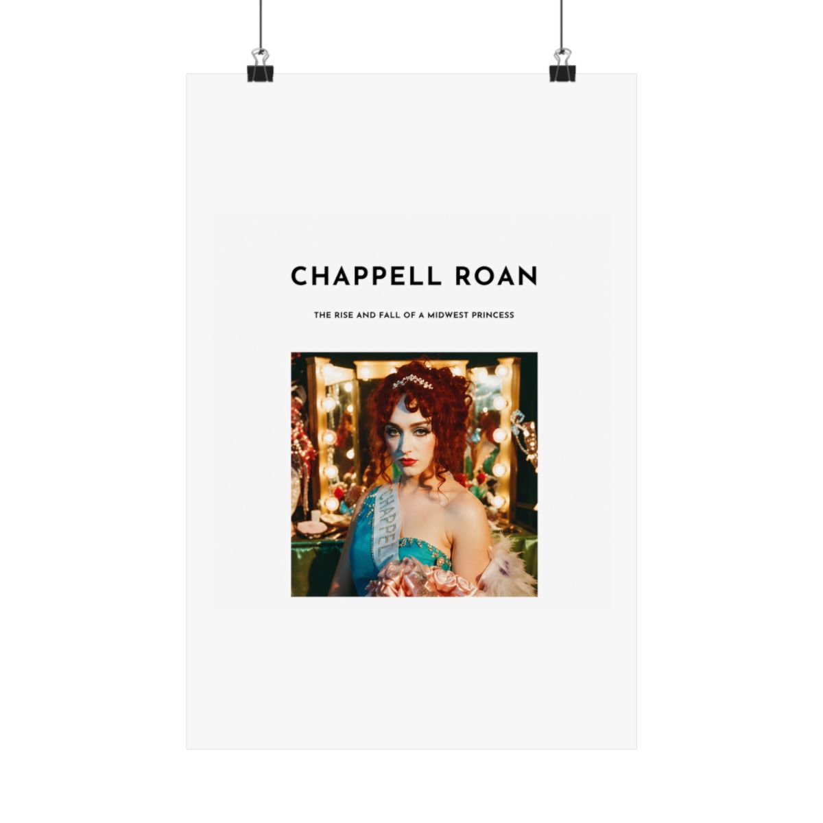 A Dresses with a white background and black text that reads "Chappell Roan, The Rise and Fall of a Midwest Princess". The Dresses features a photo of a woman with red hair wearing a blue and white...