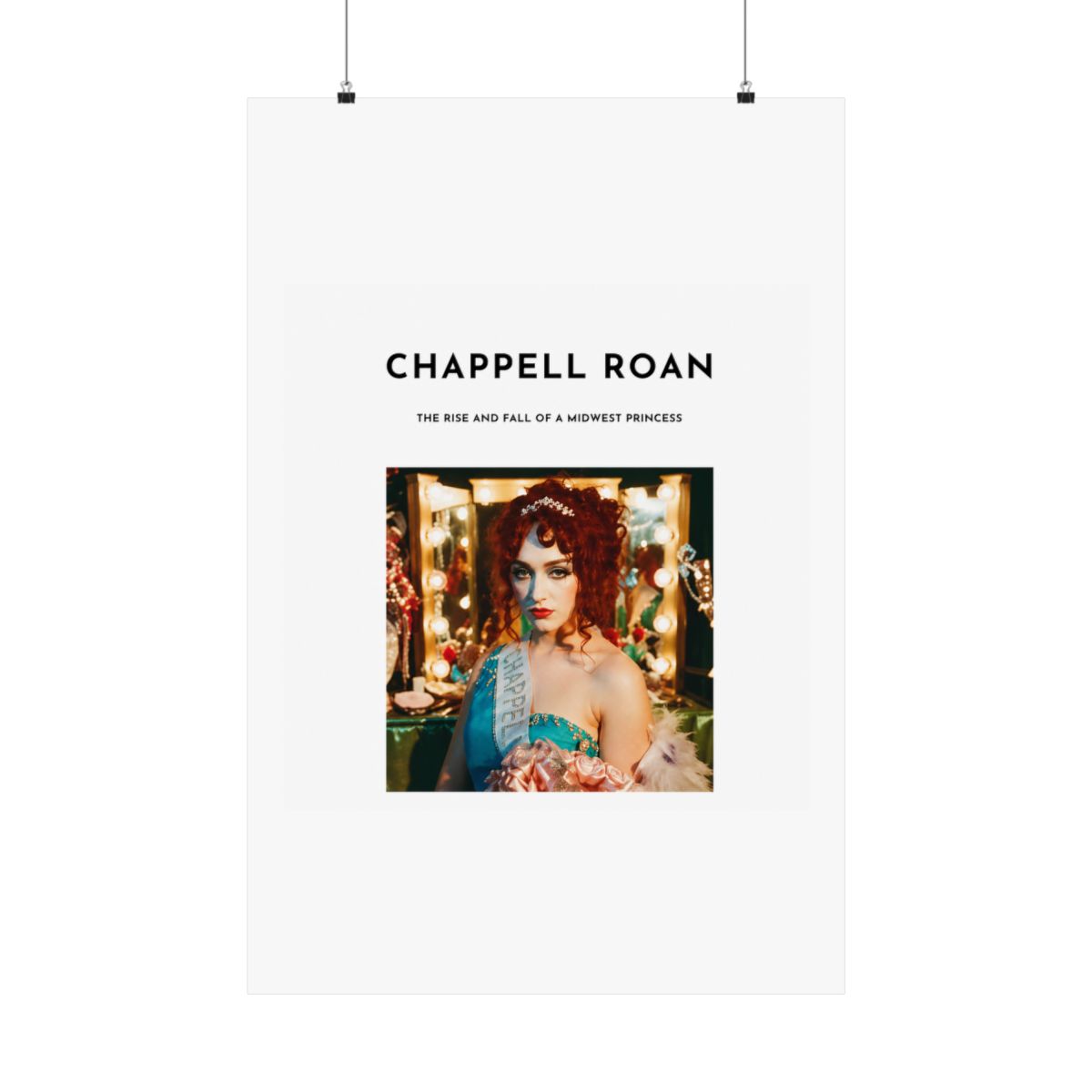 A Dresses with a white background and black text that reads "Chappell Roan, The Rise and Fall of a Midwest Princess". The Dresses features a photo of a woman with red hair wearing a blue and white... - alternate angle 2, merchandise