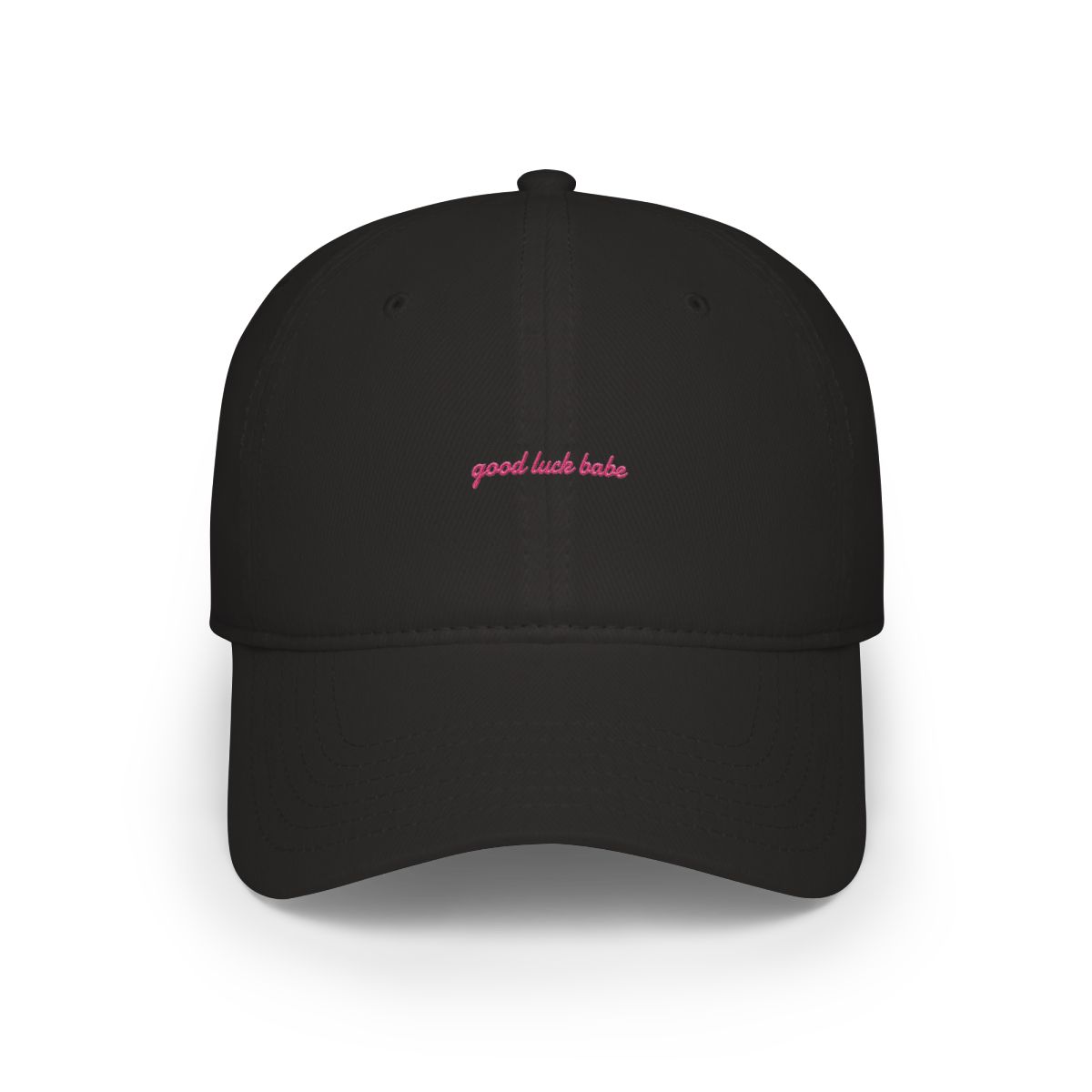 A pink baseball cap with the text "good luck babe" in pink on the front