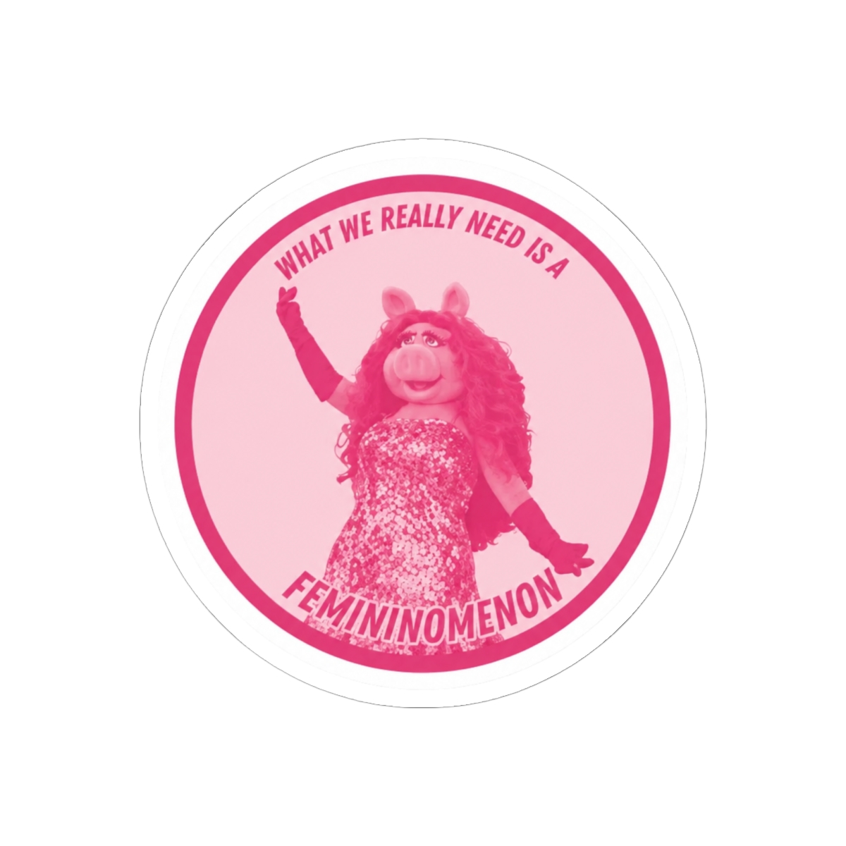Pink round sticker with a white border featuring a pink pig character with the text "What we really need is a femininomenon"
